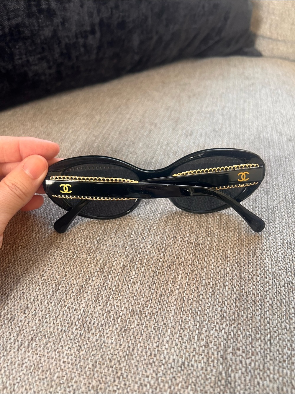 CHANEL Black Oval Sunglasses with Gold Chain Accent